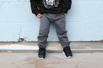Whoever said you can't be stylish AND comfortable has never tried a pair of our City Comfort Toddler Joggers by Brooklyn + Fifth! We combined a comfortable sweatshirt fabric with cozy fleece lining and added stylish design features including a mock fly, a contrasting color back logo pocket and elastic cuffs to show off your sneakers! The result is the ultimate blend of style + comfort!  These pants have taken over the fashion industry and now you can own a pair for your stylish toddler as well!  h